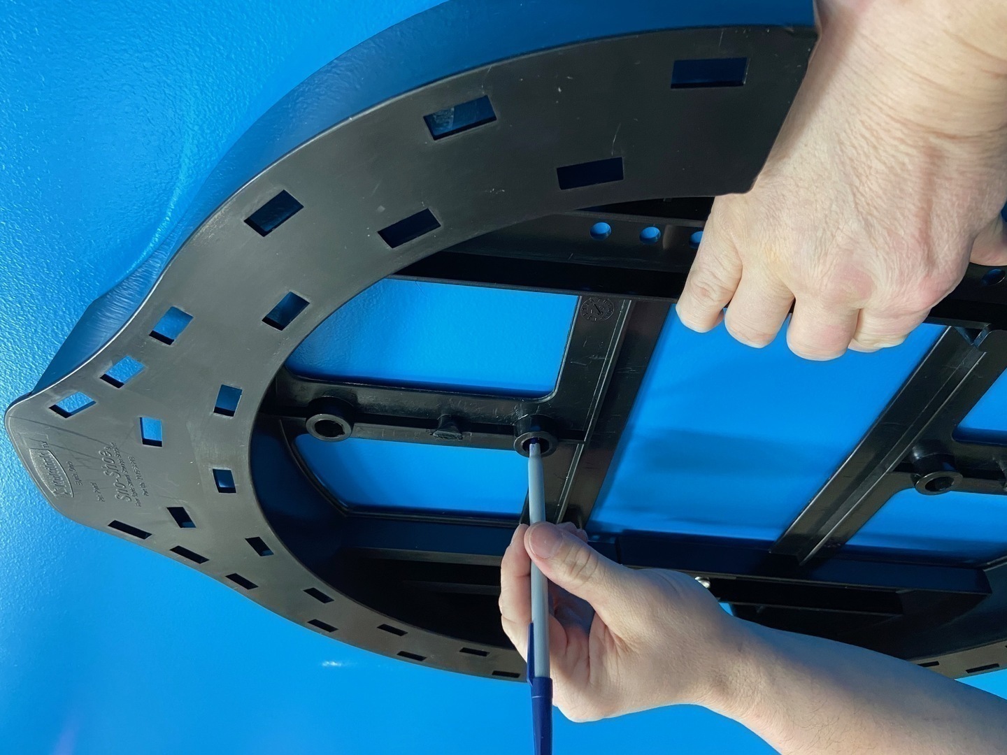 Close-up of fiber sno-shoe installation showing slack storage mounting for aerial fiber optic cable